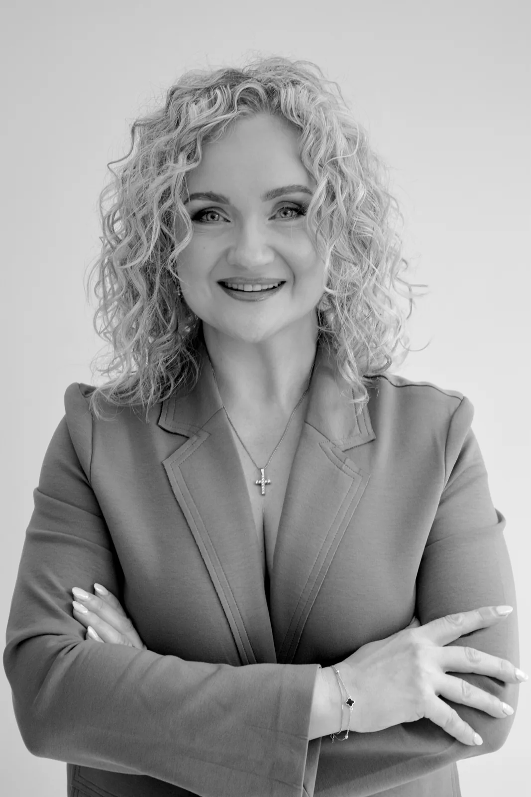Anna Fullbrook in a tailored blazer with her arms folded