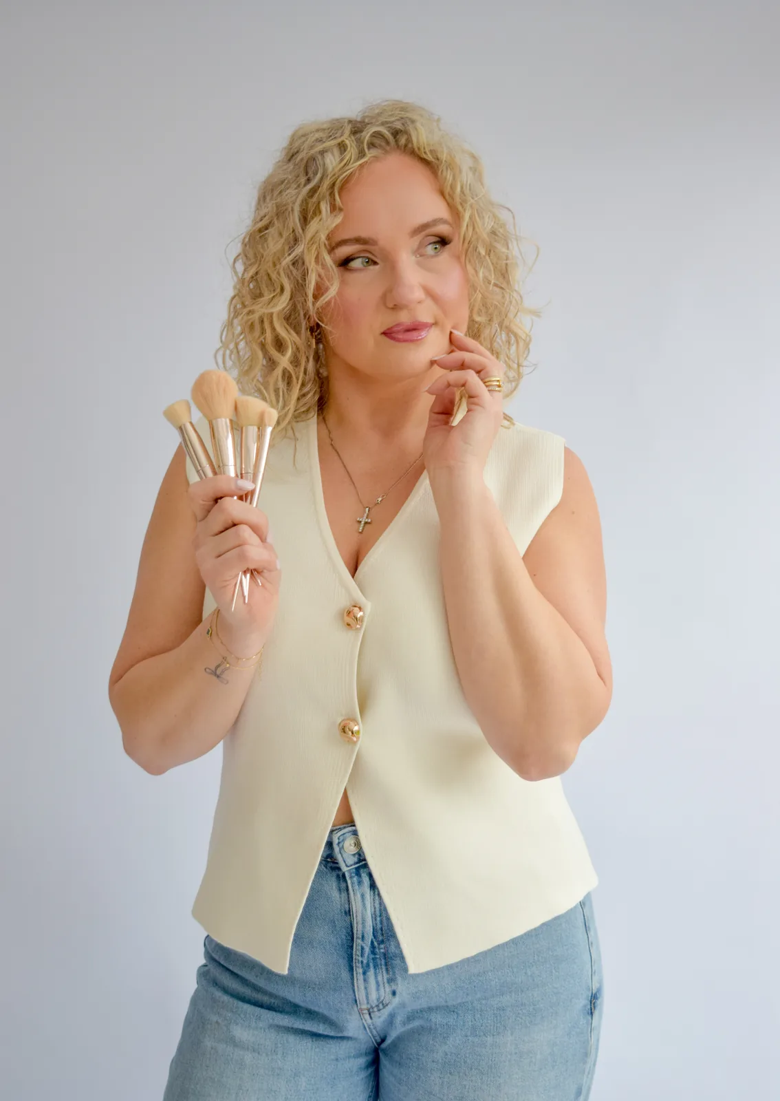 Anna Fullbrook in a cream waistcoat, holding her brushes