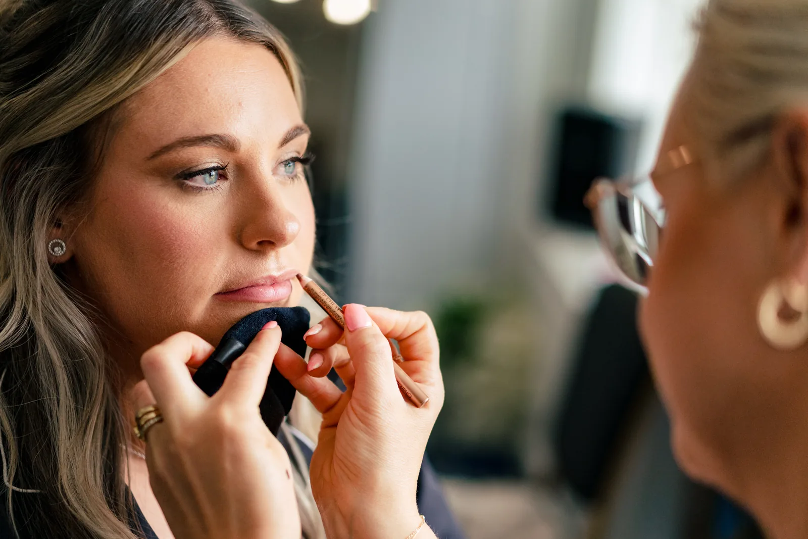 Lip colour being finished on a bride with softly defined eyes