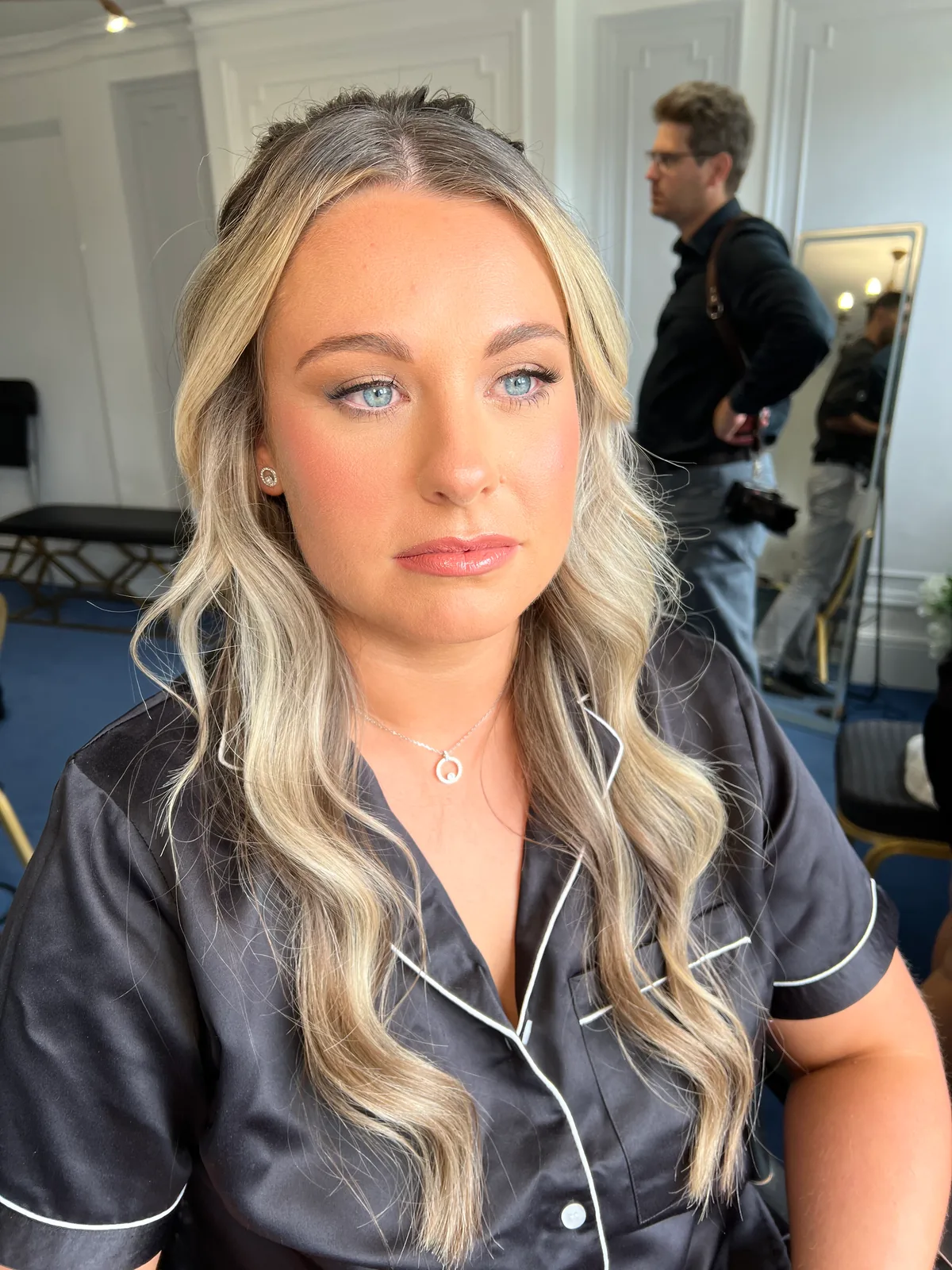 A member of the bridal party with blonde waves and softly defined makeup