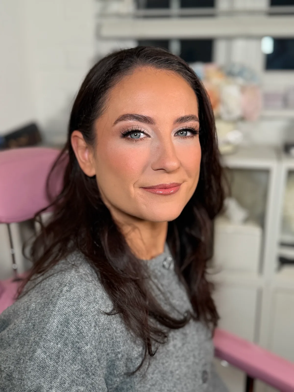 A client with bright, defined eyes and a soft sculpted finish, photographed in Anna's studio