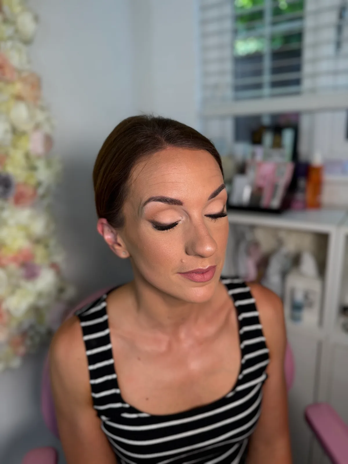 Closed eyes showing blended shimmer eyeshadow and lashes, occasion makeup
