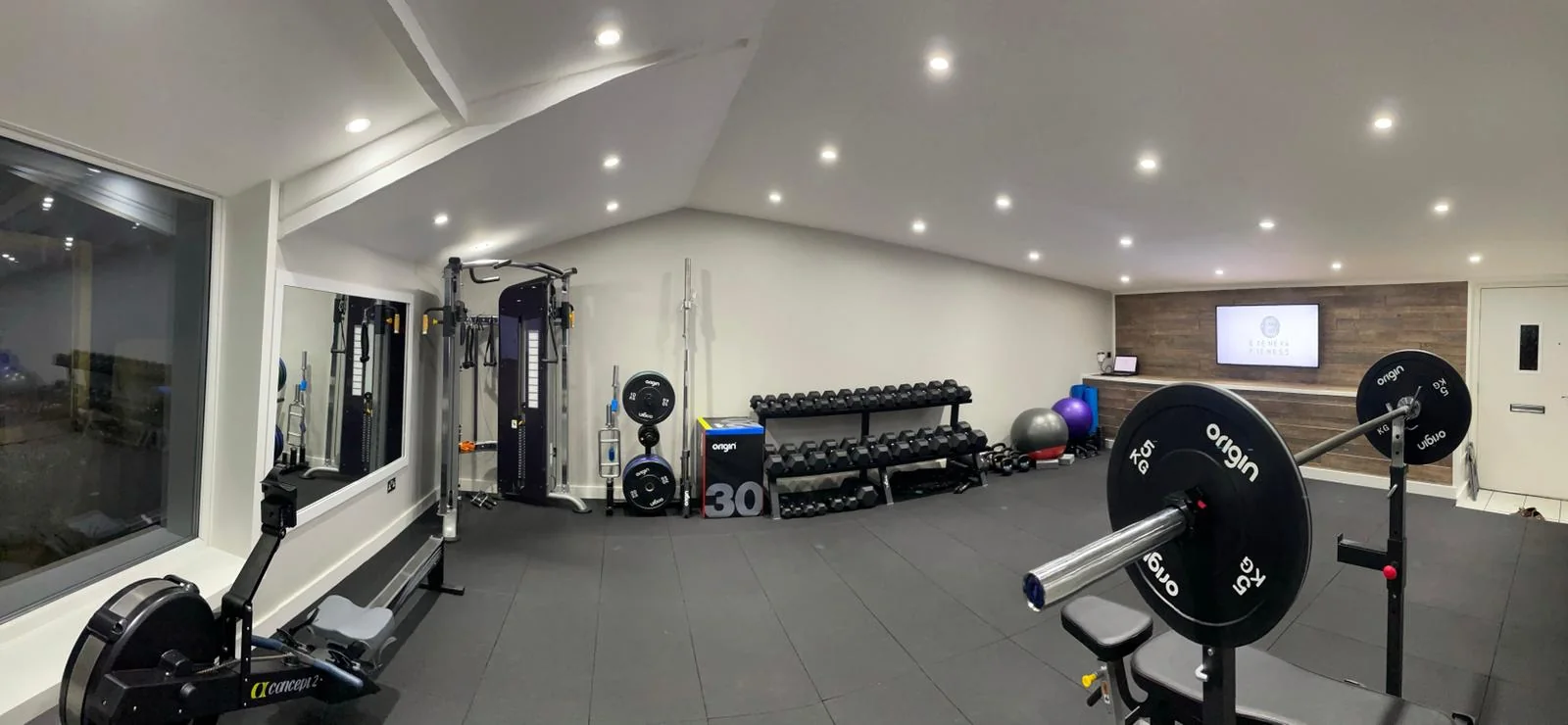 Free weights and strength equipment inside the private gym