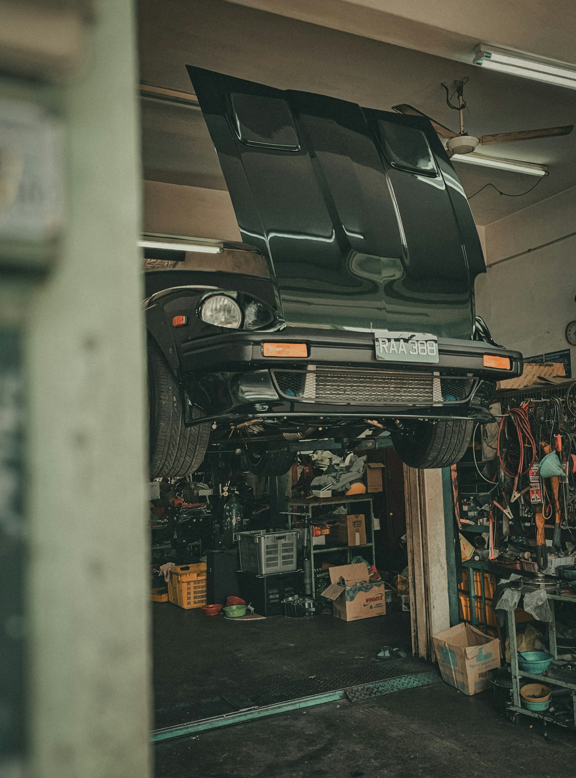 A car raised on a lift inside the garage
