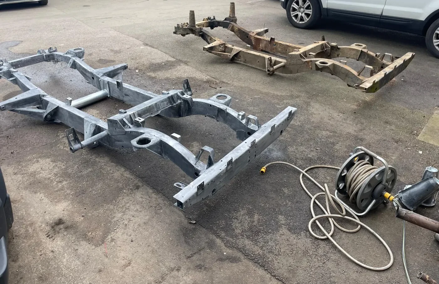 A new galvanised Land Rover chassis next to the original
