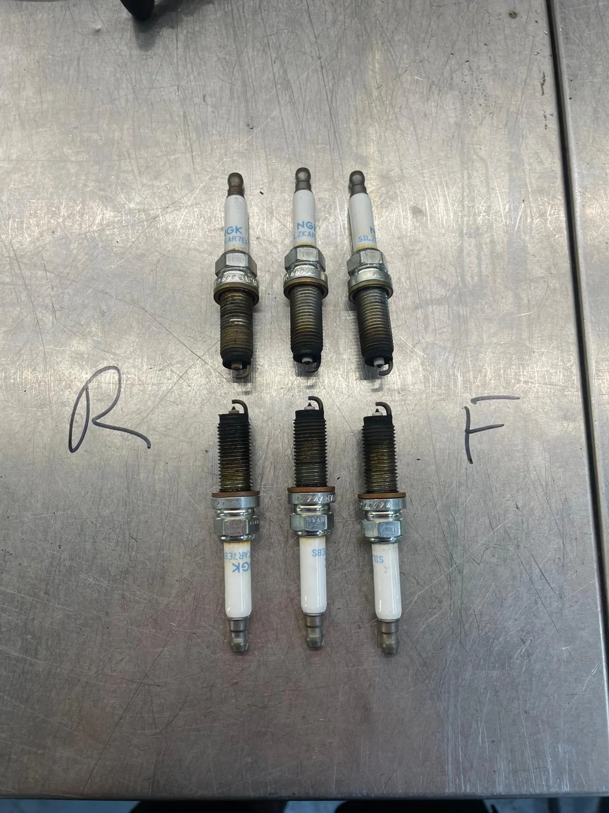 A set of spark plugs removed for inspection