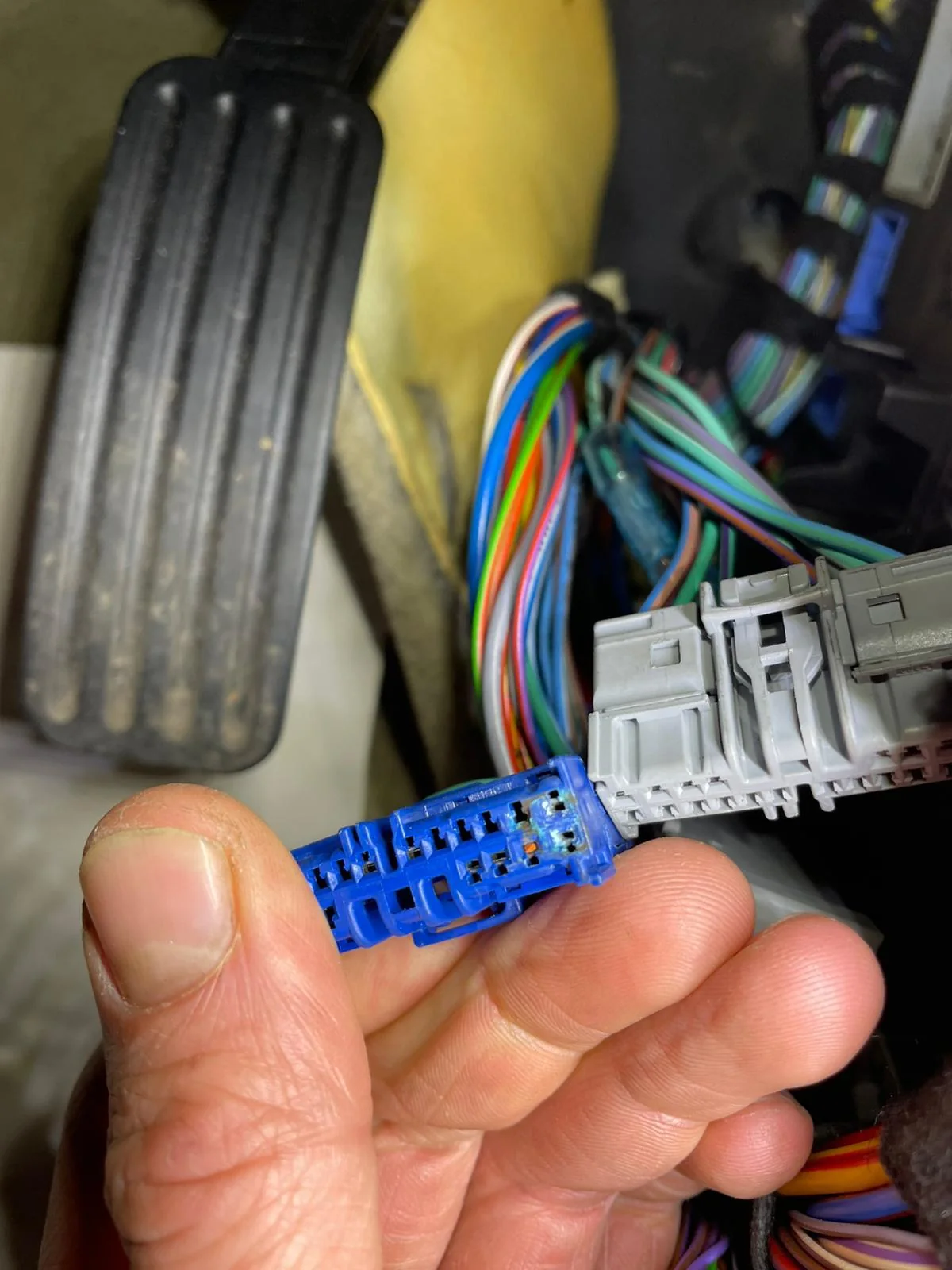 A wiring loom connector being repaired