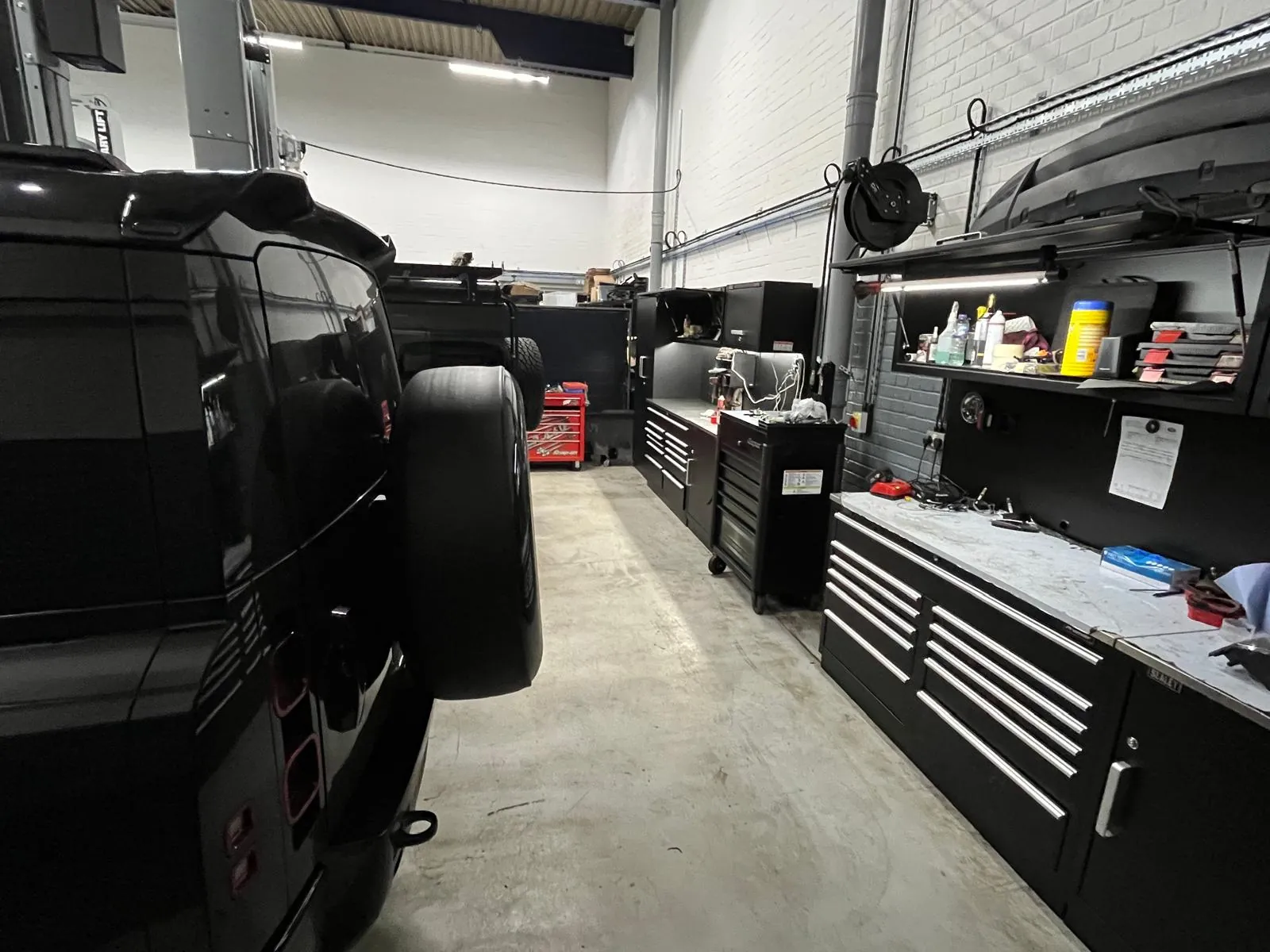 A Defender beside the tool benches in the workshop