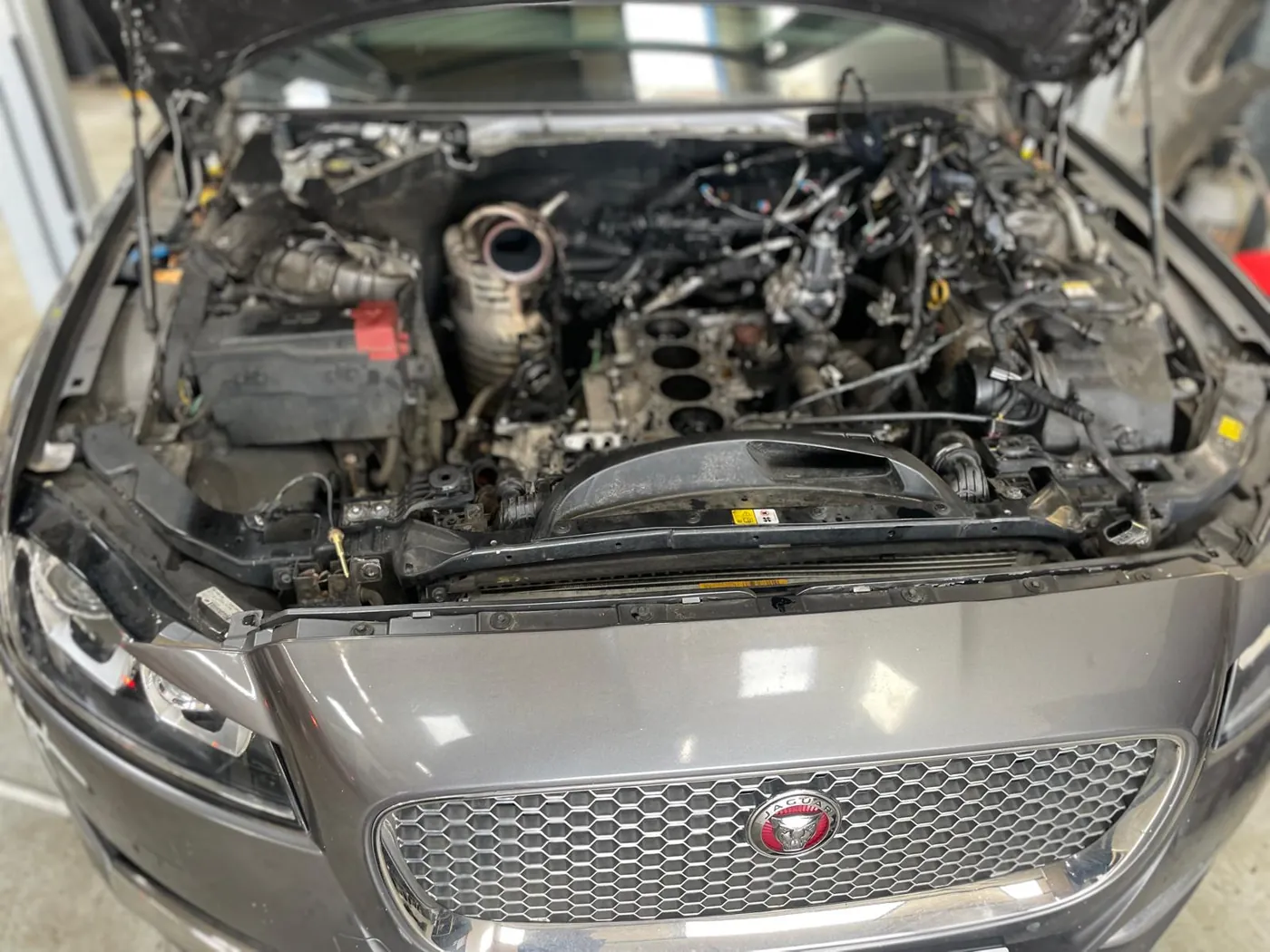 A Jaguar engine bay opened for repair